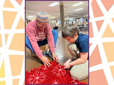 Part of the service day was creating fleece blankets for new refugee families.