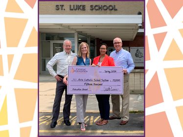 l to r: Tom Hoffman (Foundation board member) and Lisa Louis (Executive Director) present grant check to Erie Catholic School System representatives Nicole Reitzell (Vice President of Advancement) and John Blakeslee (Board Member)