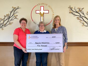 Lisa Louis, Executive Director (far right) presents grant check to Sister Suzanne Thibault, CA and Sister Ruth Ann Madera, CA of Anawim Ministries.